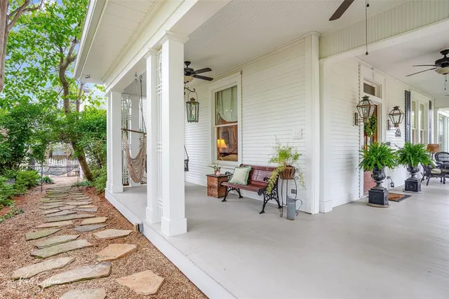 a view of a patio with a table and chairs and potted plants
