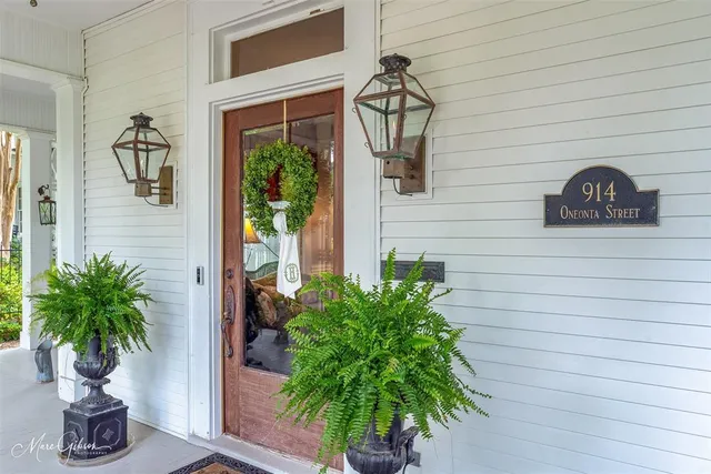 a vase of flowers sitting on a wooden floor