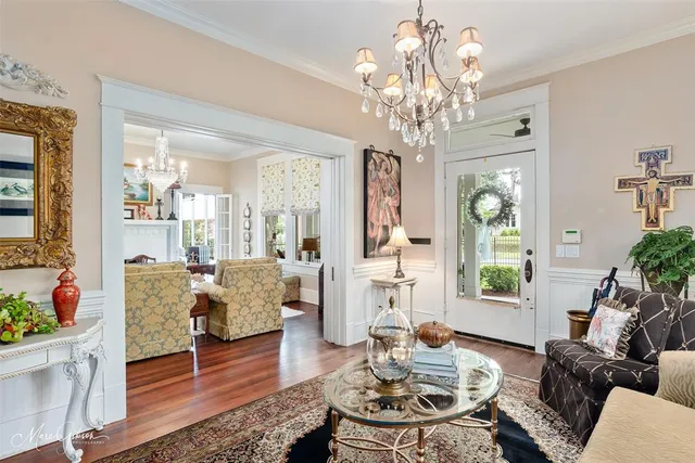 a living room with furniture chandelier and a chandelier