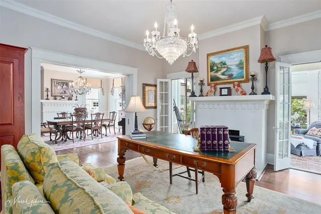 a living room with furniture a chandelier and a table