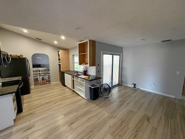 1142 Southwest Bayamo Avenue Port St. Lucie, FL 34953 - Photo 11 of 19 a view of a living room a dining room with wooden floor and furniture