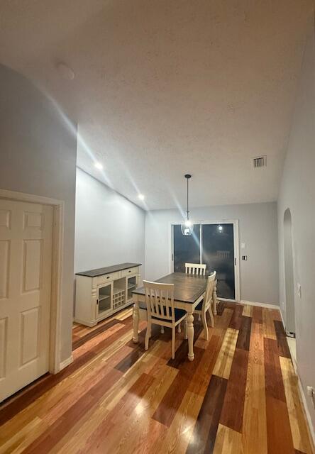 1142 Southwest Bayamo Avenue Port St. Lucie, FL 34953 - Photo 9 of 19 a room with wooden floor pool table and chairs