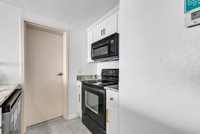 a kitchen with stainless steel appliances a stove microwave and refrigerator