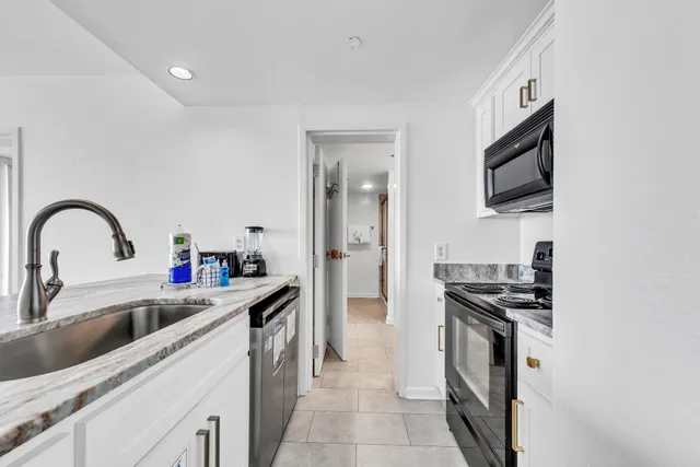 a kitchen with stainless steel appliances a sink a stove and a refrigerator