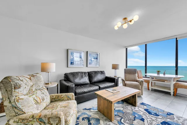 a living room with furniture and a lamp