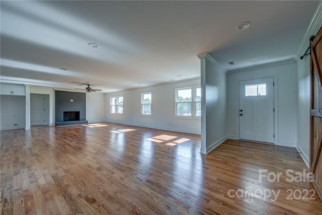 649 Loray Farm Road Dallas, NC 28034 - Photo 11 of 44 a view of empty room with window and wooden floor