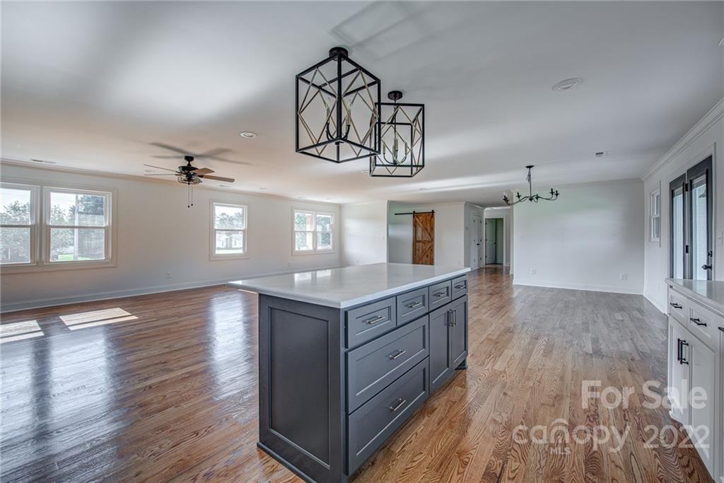 649 Loray Farm Road Dallas, NC 28034 - Photo 18 of 44 a open kitchen with kitchen island granite countertop wooden floors and wide window