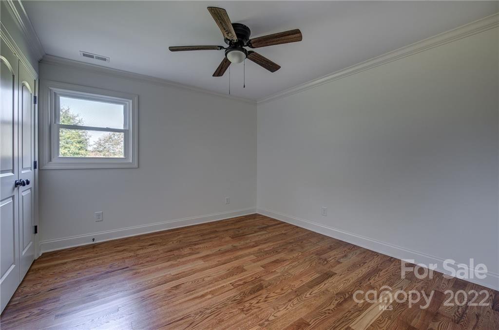 649 Loray Farm Road Dallas, NC 28034 - Photo 24 of 44 an empty room with wooden floor and windows