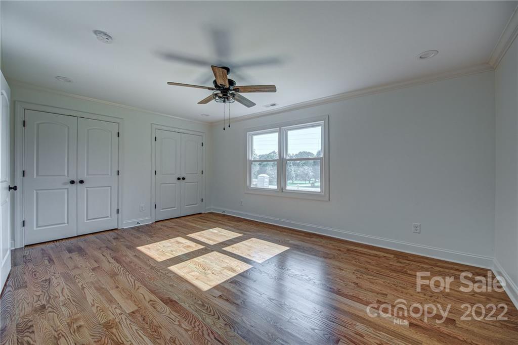 649 Loray Farm Road Dallas, NC 28034 - Photo 28 of 44 a view of empty room with wooden floor and fan