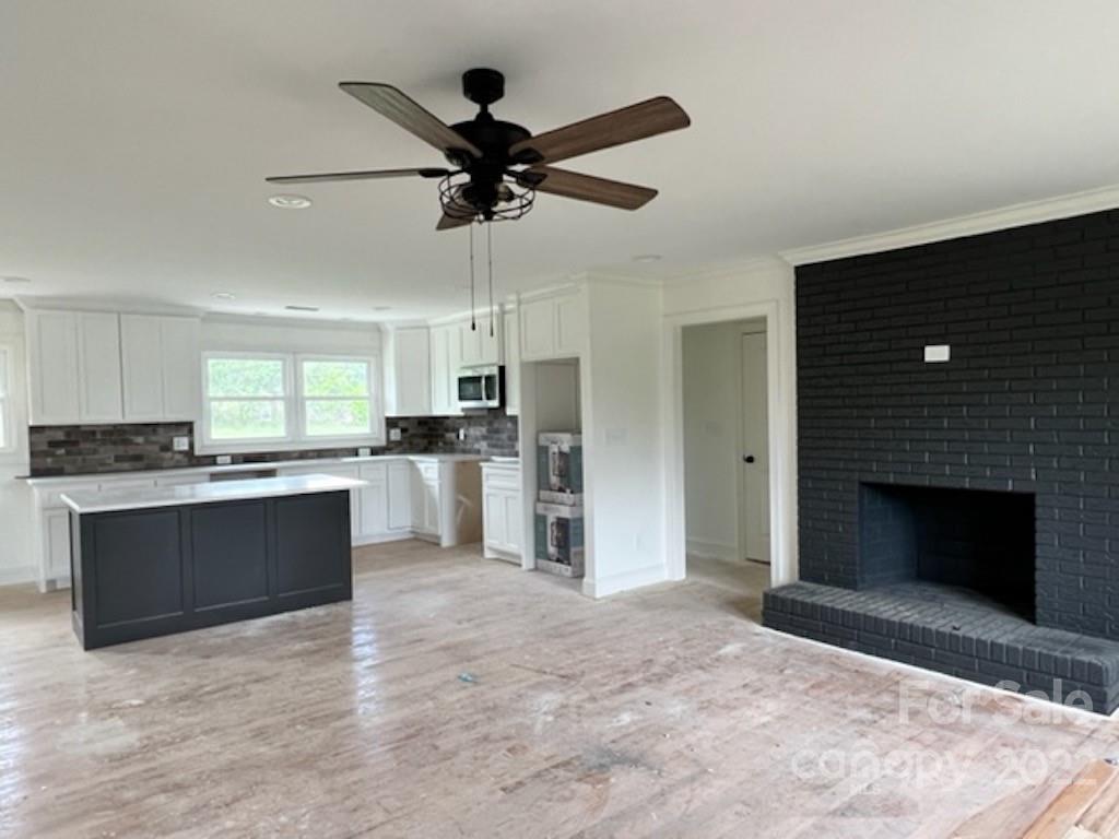 649 Loray Farm Road Dallas, NC 28034 - Photo 8 of 44 a large kitchen with a stove and a refrigerator with wooden floor