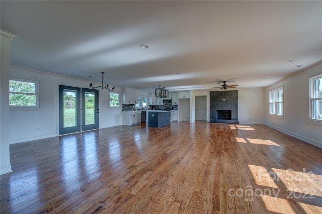 649 Loray Farm Road Dallas, NC 28034 - Photo 10 of 44 an empty room with wooden floor and windows