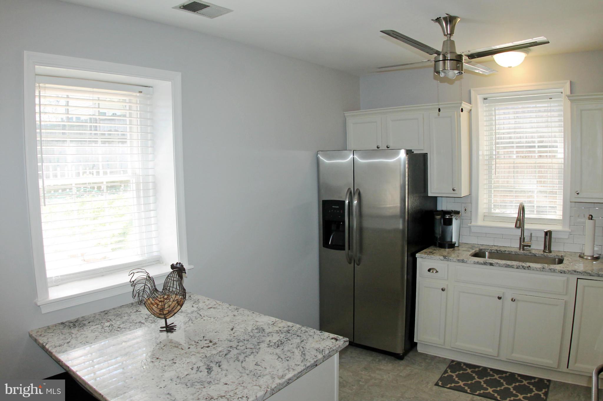 26722 Ridge Road Damascus, MD 20872 - Photo 11 of 30 a kitchen with a refrigerator a sink and a window