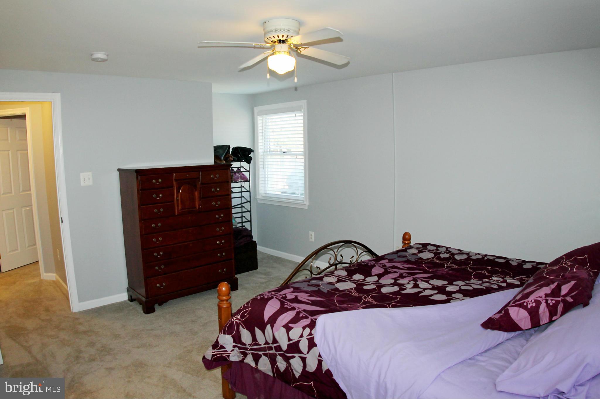 26722 Ridge Road Damascus, MD 20872 - Photo 17 of 30 a bedroom with a bed and a chandelier