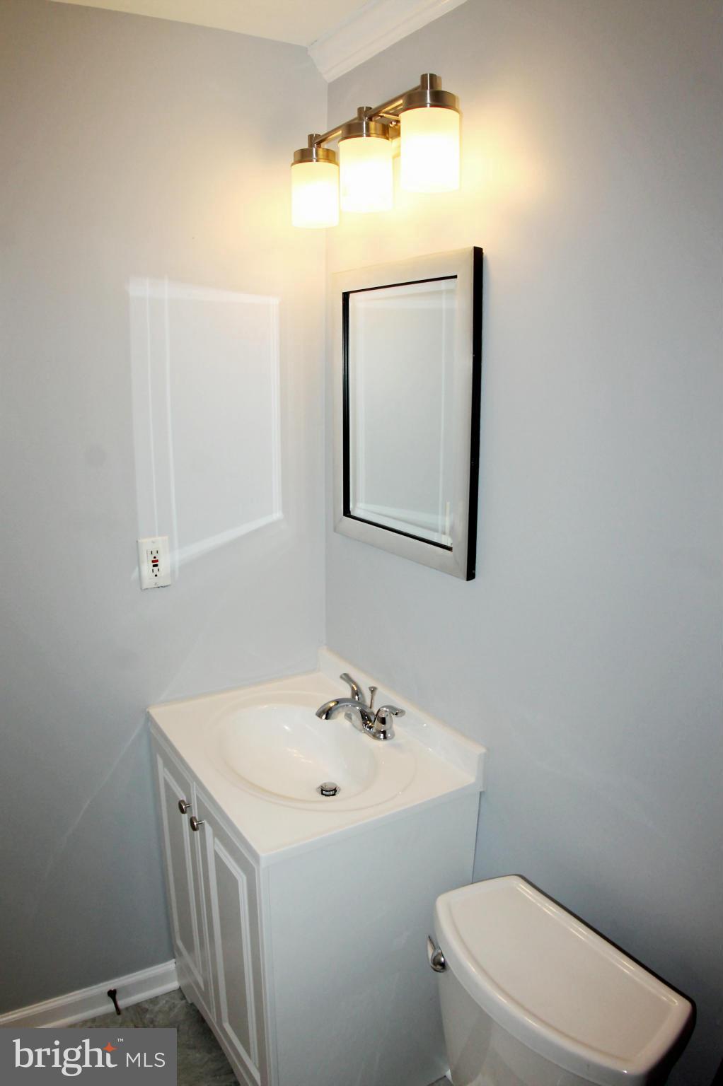 26722 Ridge Road Damascus, MD 20872 - Photo 18 of 30 a bathroom with a sink a toilet and mirror
