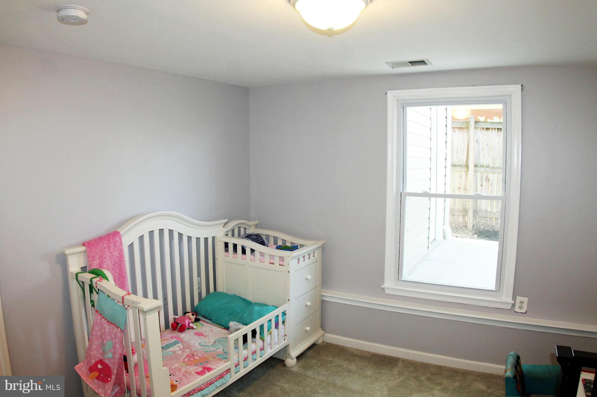26722 Ridge Road Damascus, MD 20872 - Photo 19 of 30 a bedroom with baby crib and a window