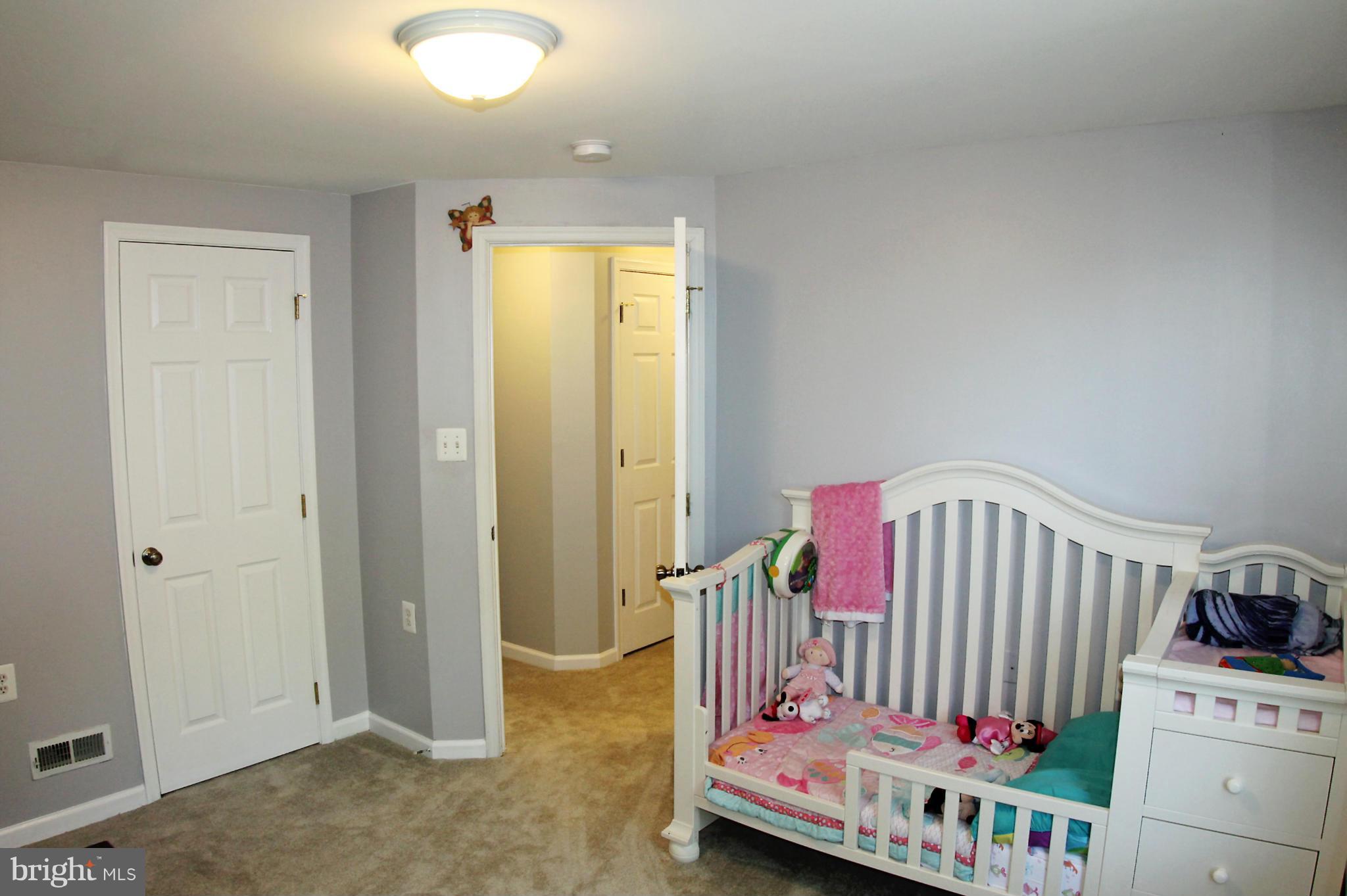 26722 Ridge Road Damascus, MD 20872 - Photo 20 of 30 a view of a bedroom with baby crib and toys