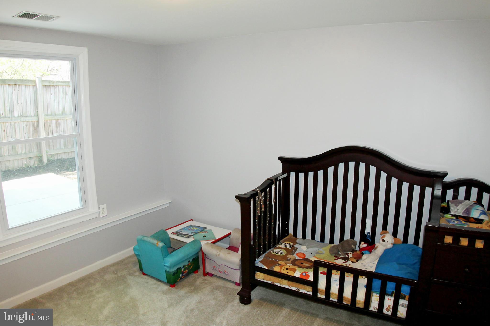 26722 Ridge Road Damascus, MD 20872 - Photo 22 of 30 a bedroom with a window and a wooden floor