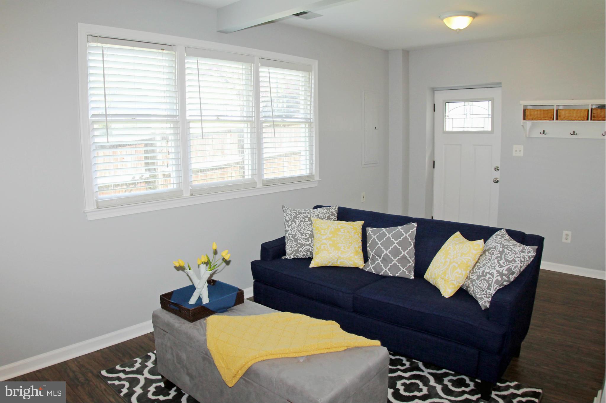 26722 Ridge Road Damascus, MD 20872 - Photo 5 of 30 a living room with furniture and a potted plant