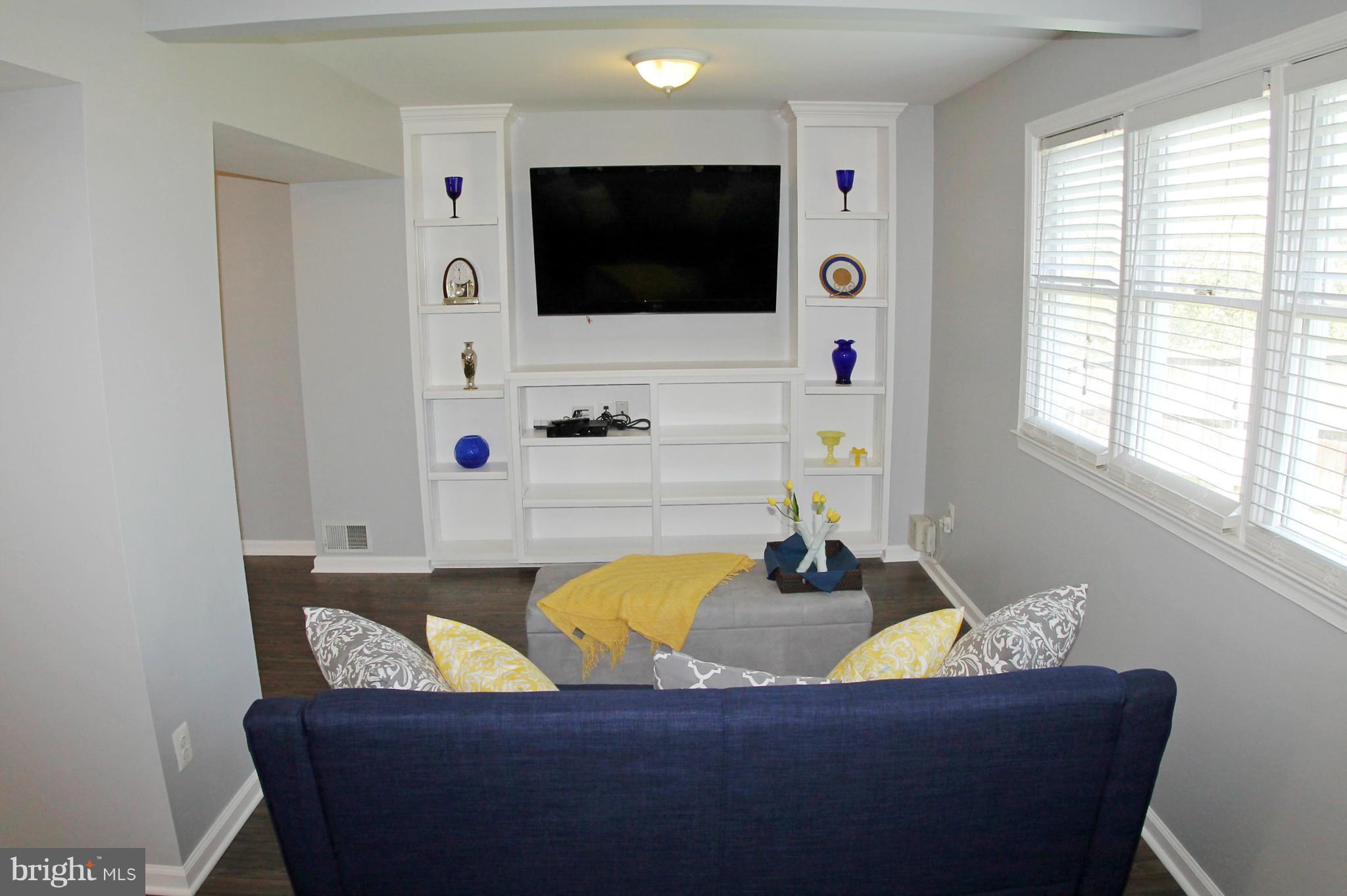 26722 Ridge Road Damascus, MD 20872 - Photo 6 of 30 a living room with furniture and a flat screen tv