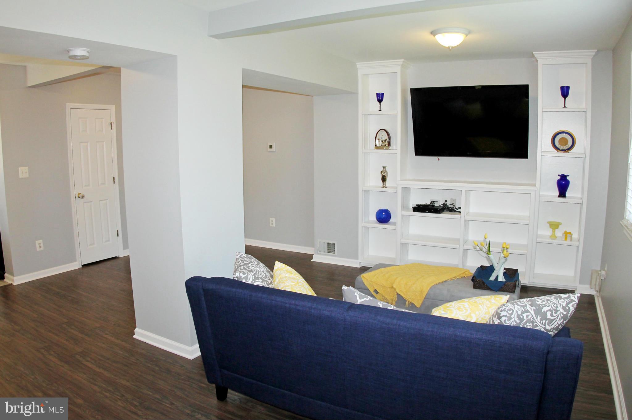 26722 Ridge Road Damascus, MD 20872 - Photo 7 of 30 a living room with furniture and a flat screen tv