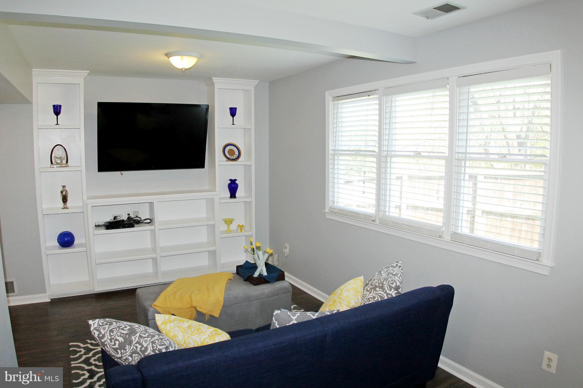 26722 Ridge Road Damascus, MD 20872 - Photo 8 of 30 a living room with furniture and a flat screen tv