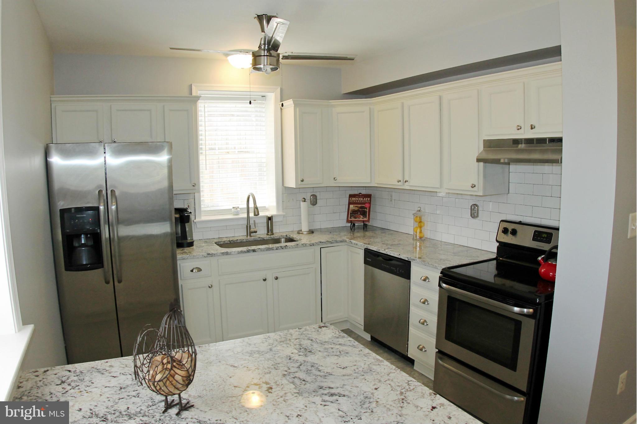 26722 Ridge Road Damascus, MD 20872 - Photo 10 of 30 a kitchen with stainless steel appliances granite countertop a stove a refrigerator and a sink