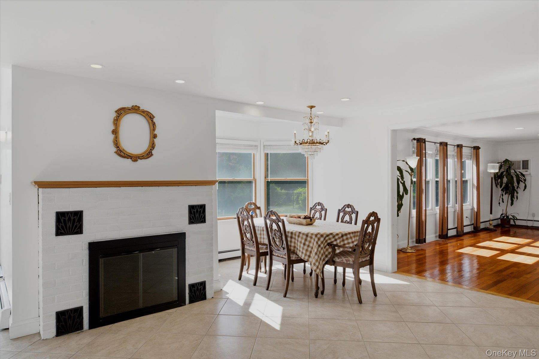 498 Miller Place Road Miller Place, NY 11764 - Photo 35 of 37 Open floor plan with wood fireplace, dining room and living room