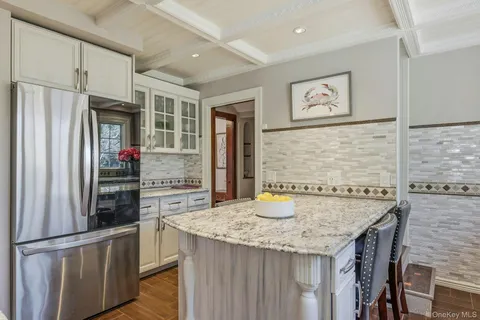 a kitchen with a table chairs and refrigerator