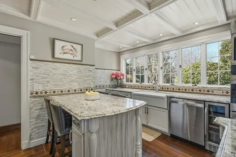 a kitchen with granite countertop a sink and wooden cabinets