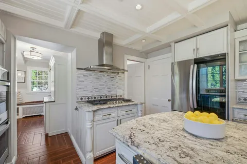 a kitchen with a stove and a wooden cabinets