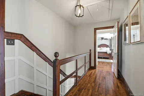 a view of a hallway view with wooden floor and staircase