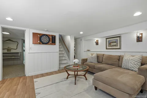 a living room with furniture and a view of kitchen