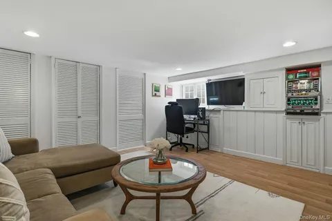 a living room with furniture a flat screen tv and a window