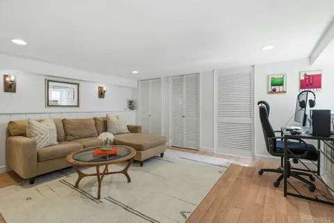 a living room with furniture a piano and a window