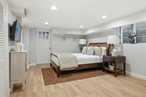 a bedroom with a bed and a flat screen tv