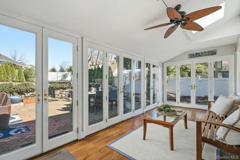 a living room with furniture and a floor to ceiling window