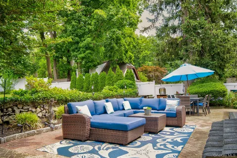 a patio with patio a table and chairs under an umbrella
