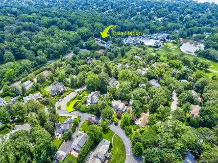 a aerial view of a house with a swimming pool and green space