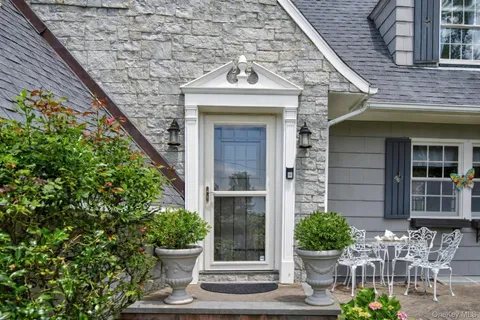 a front view of a house with chairs
