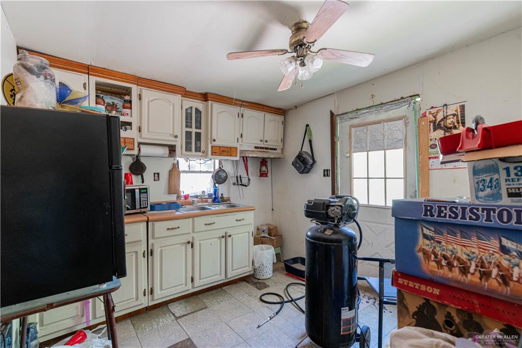 2713 South Midway Road Weslaco, TX 78596 - Photo 11 of 17 a kitchen that has a lot of cabinets furniture and appliances