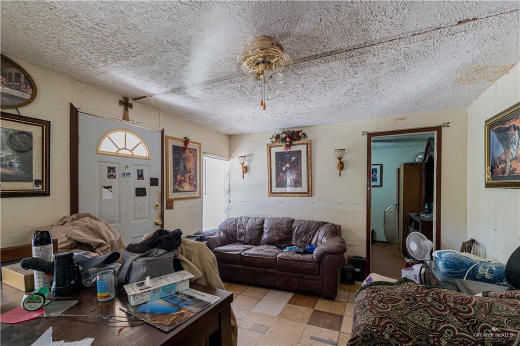 2713 South Midway Road Weslaco, TX 78596 - Photo 7 of 17 a living room with furniture chess board and a chandelier