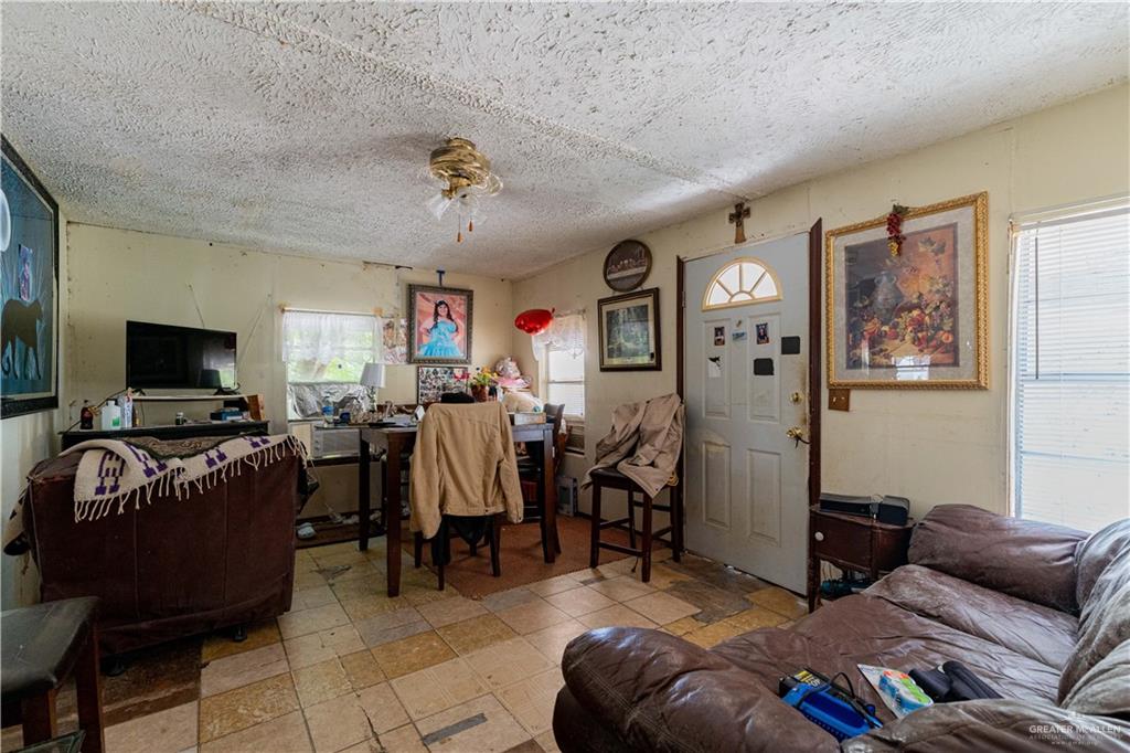 2713 South Midway Road Weslaco, TX 78596 - Photo 8 of 17 a living room with furniture and a flat screen tv