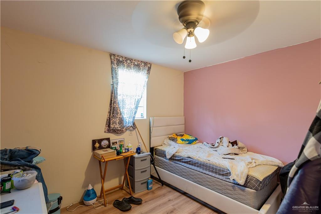 2713 South Midway Road Weslaco, TX 78596 - Photo 9 of 17 a bedroom with a bed and a chandelier