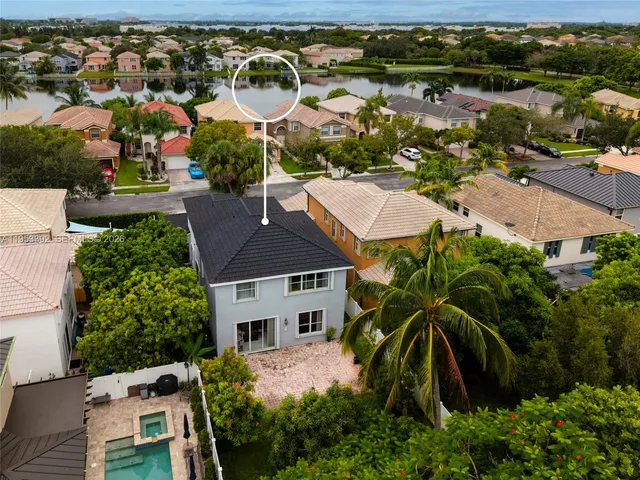 an aerial view of a house with yard swimming pool and outdoor seating
