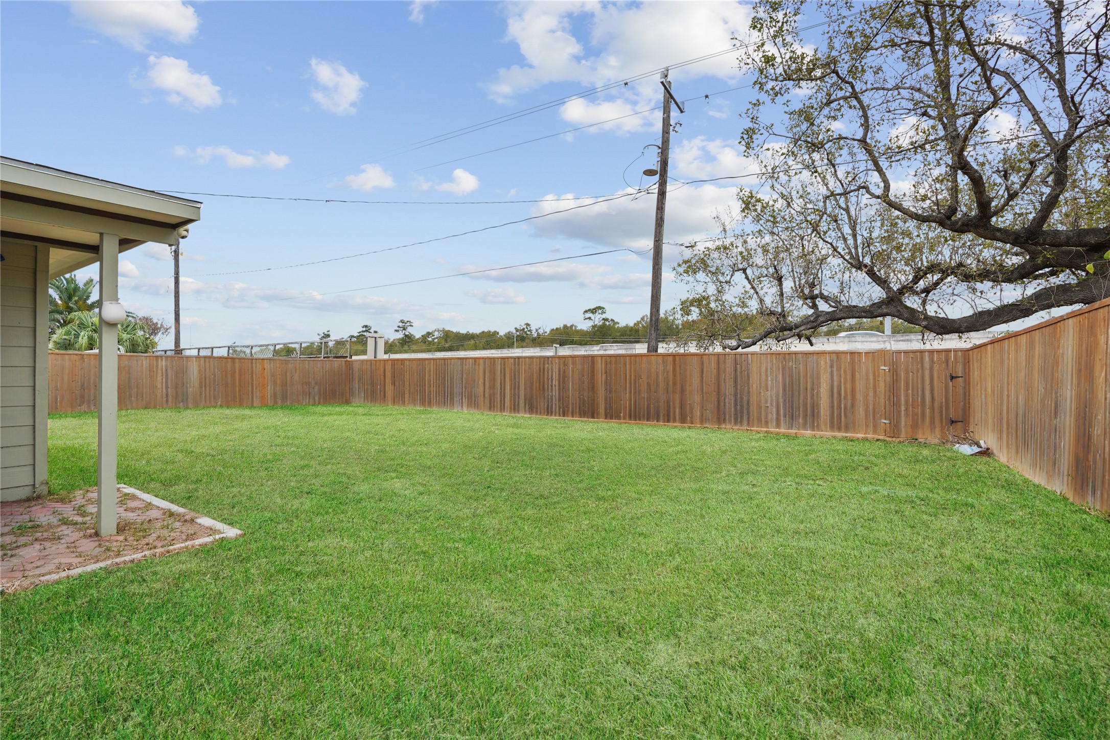 623 Rockbrook Drive Houston, TX 77015 - Photo 17 of 17 a view of a backyard with grass & fence