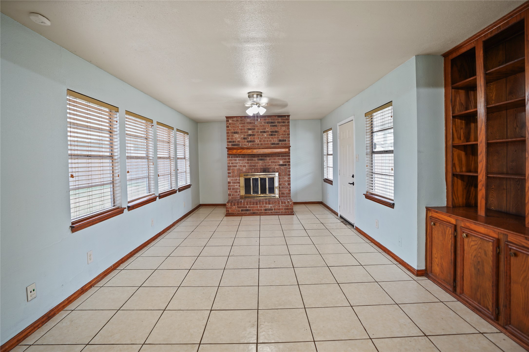 623 Rockbrook Drive Houston, TX 77015 - Photo 7 of 17 a view of an empty room with window and cabinet