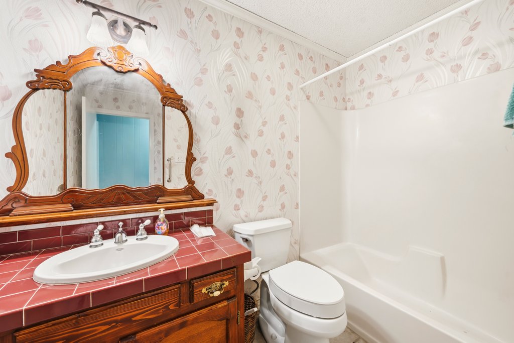 1961 Bolton Road Marion, TX 78124 - Photo 12 of 17 a bathroom with a sink a toilet and a mirror