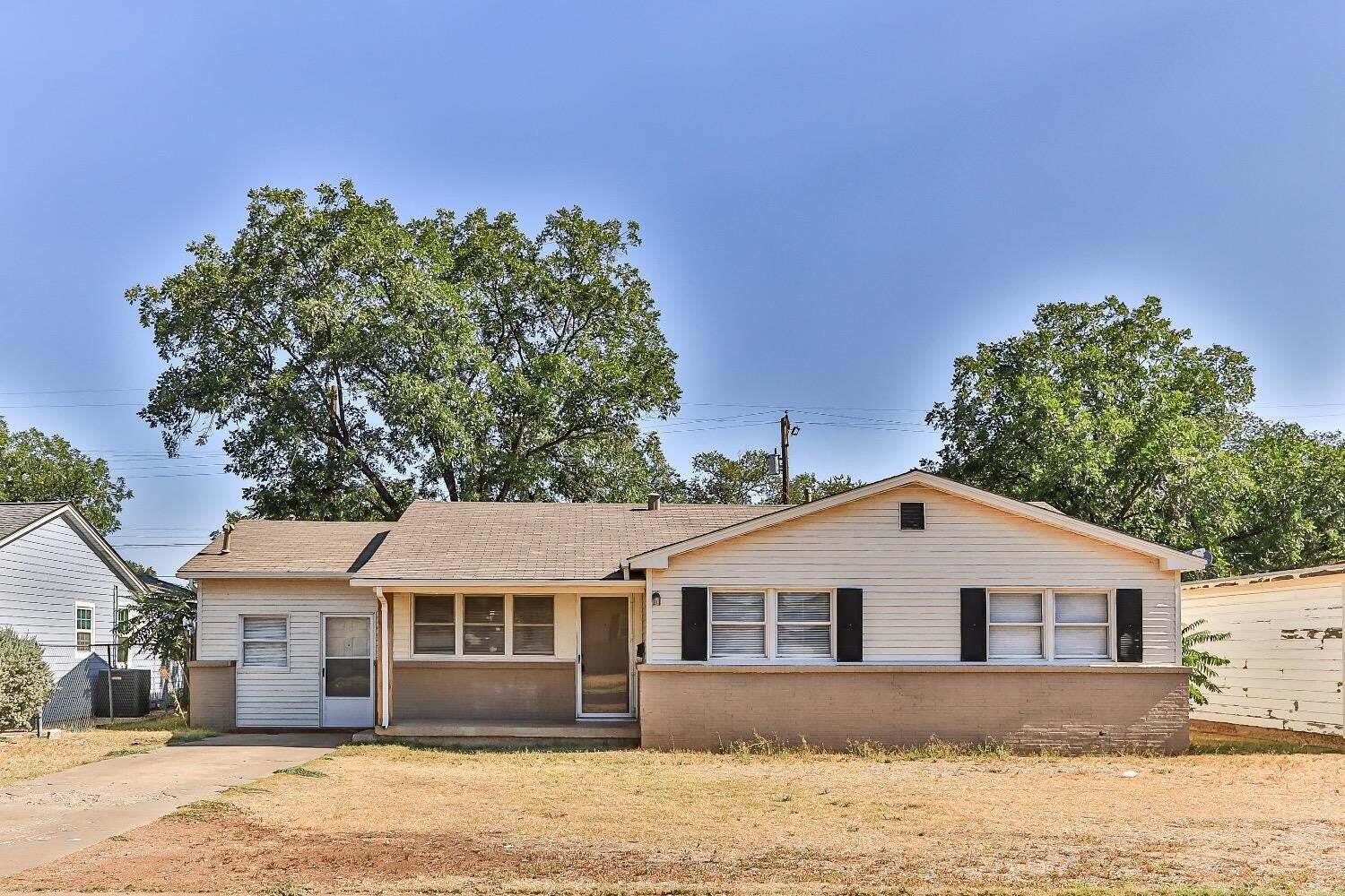 4212 42nd Street Lubbock, TX 79413 - Photo 1 of 18 a front view of a house with a yard