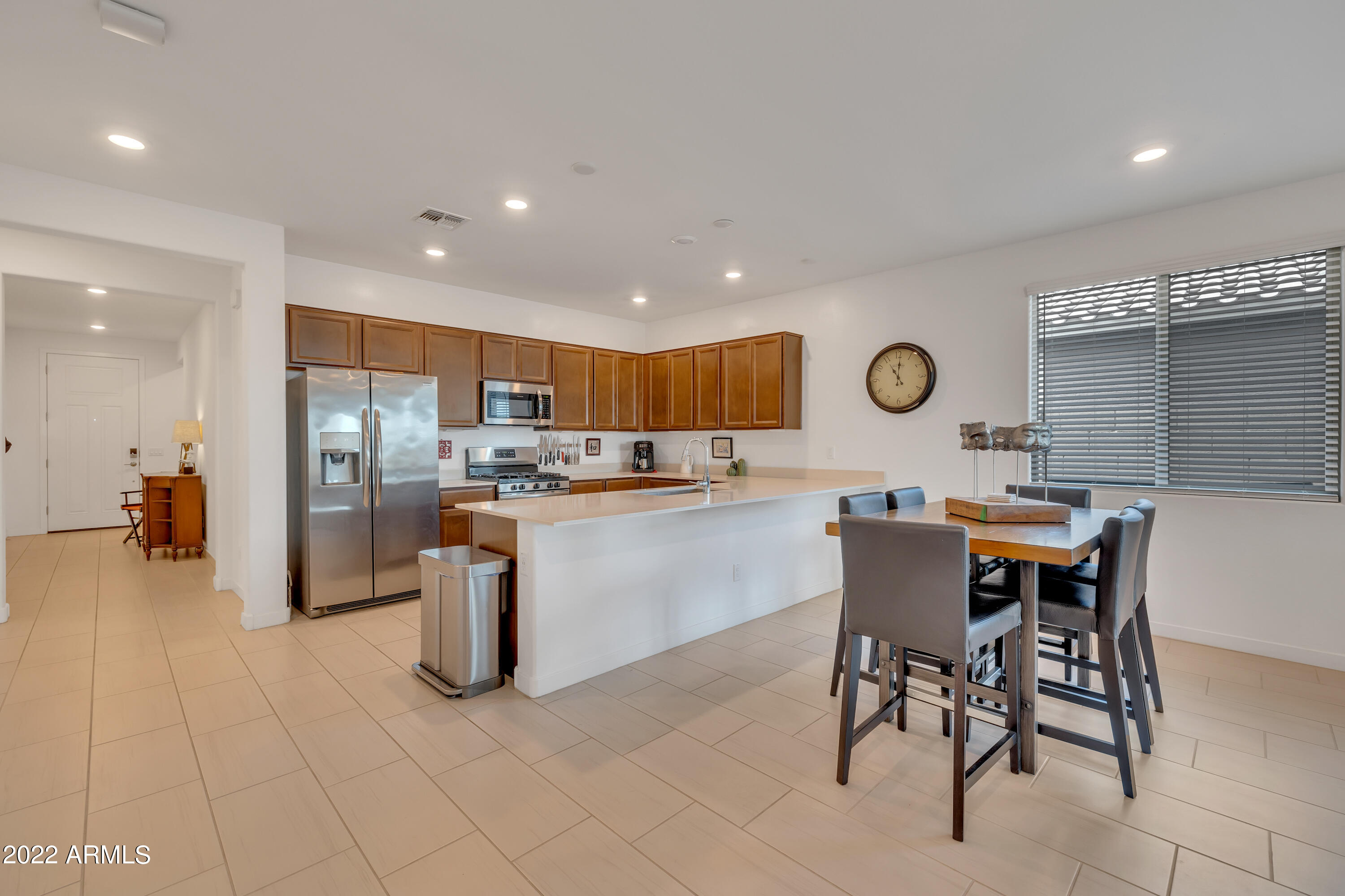 9630 West Atlantis Way Tolleson, AZ 85353 - Photo 12 of 37 a kitchen with stainless steel appliances kitchen island granite countertop a sink and cabinets