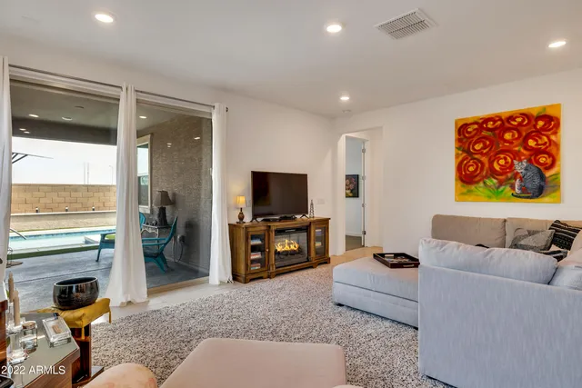 a living room with furniture and a flat screen tv with wooden floor